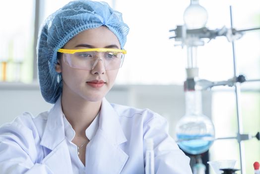 Asian young girl student scientist researching  and learning in a laboratory.