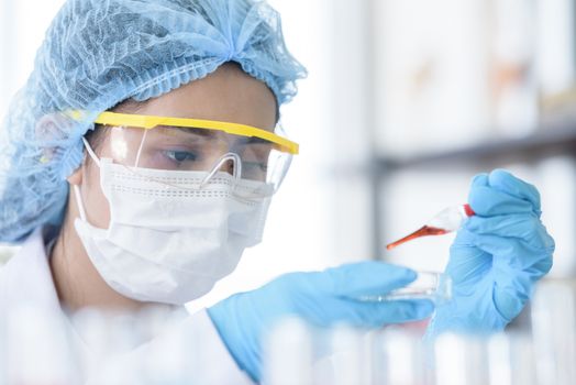 Asian young girl student scientist researching  and learning in a laboratory.