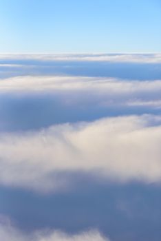 The blue skyline with cloudy in sunrise time, view from window on the plane.