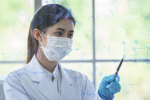 Asian young girl student scientist has writing and researching in laboratory.