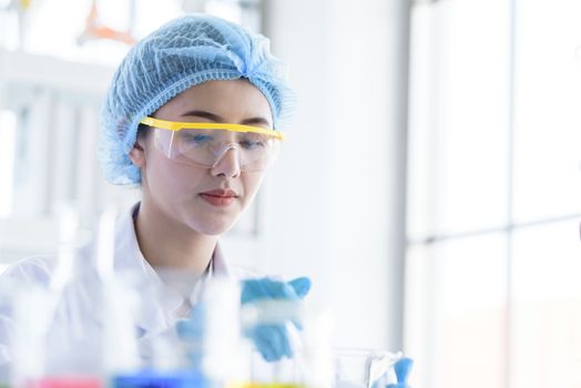 Asian young girl student scientist researching  and learning in a laboratory.