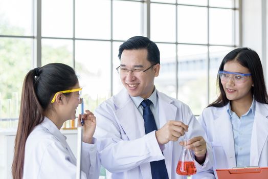 Asian senior laboratory scientist man working at lab with asian young student scientist backgroud.