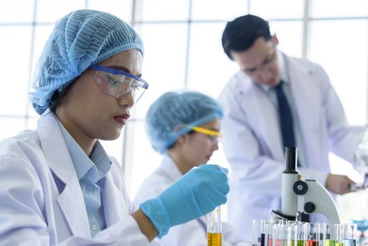 Asian young girl student scientist researching  and learning in a laboratory.