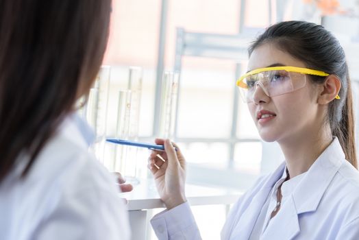 Asian young female working and research scientist together.