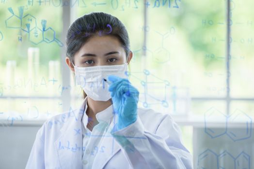 Asian young girl student scientist has writing and researching in laboratory.