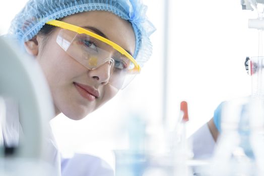 Asian young girl student scientist researching  and learning in a laboratory.