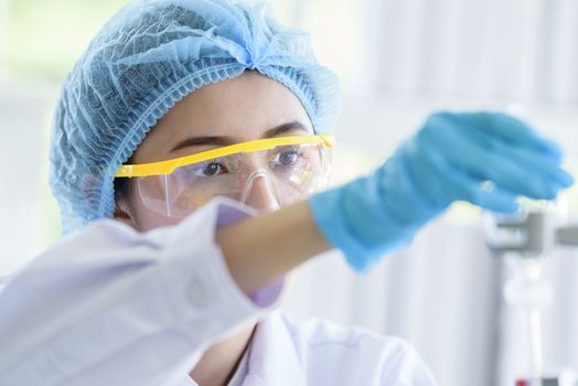 Asian young girl student scientist researching  and learning in a laboratory.