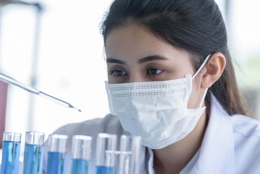 Asian young girl student scientist researching  and learning in a laboratory.