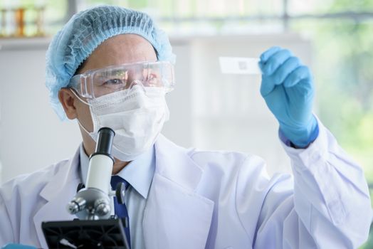 Asian man scientist researching  and learning in a laboratory.