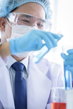 Asian man scientist researching  and learning in a laboratory.