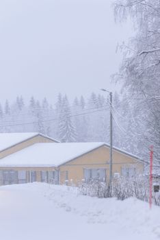 The house in the forest has covered with heavy snow and bad sky in winter season at Lapland, Finland.