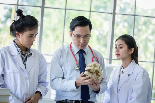 Asian teacher has teaching to student about science and anatomical in laboratory