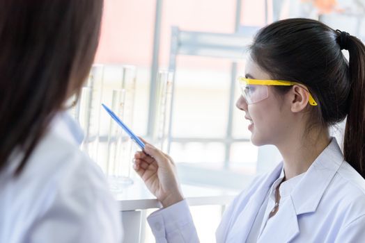 Asian young female working and research scientist together.