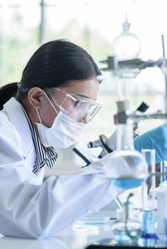 Asian young girl student scientist researching  and learning in a laboratory.