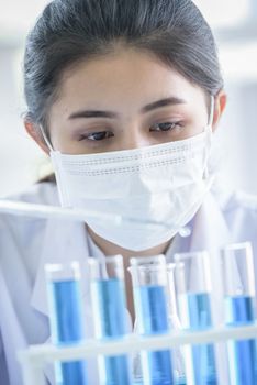 Asian young girl student scientist researching  and learning in a laboratory.