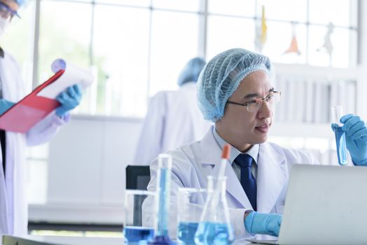 Asian senior scientist male researching and learning in a laboratory.