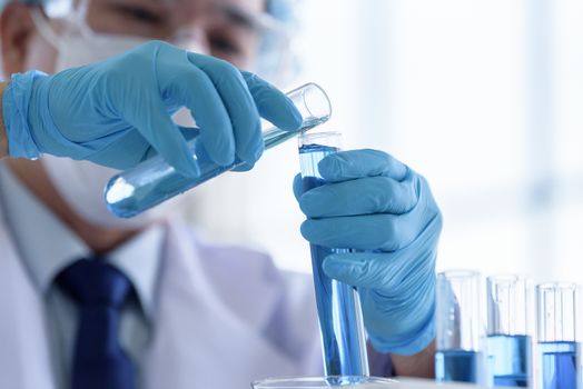 Asian man scientist researching  and learning in a laboratory.