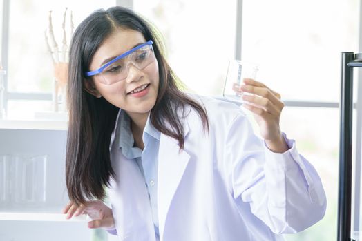 Asian young girl student scientist researching  and learning in a laboratory.