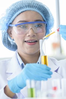 Asian young girl student scientist researching  and learning in a laboratory.