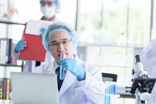 Asian senior scientist male researching and learning in a laboratory.