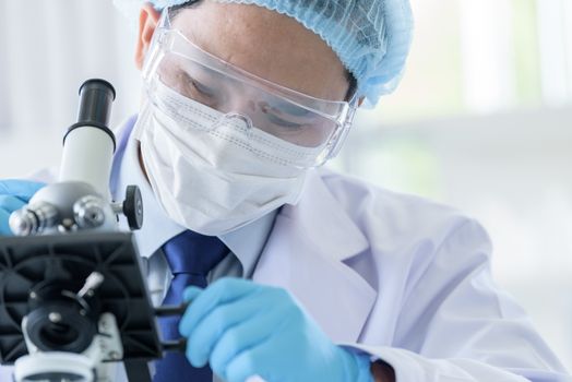 Asian man scientist researching  and learning in a laboratory.