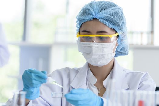 Asian young girl student scientist researching  and learning in a laboratory.