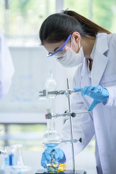 Asian young girl student scientist researching  and learning in a laboratory.