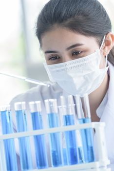 Asian young girl student scientist researching  and learning in a laboratory.