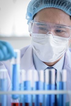 Asian man scientist researching  and learning in a laboratory.