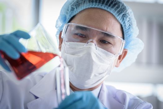 Asian man scientist researching  and learning in a laboratory.