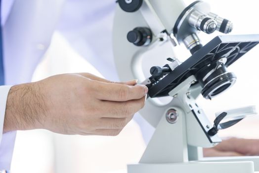 Asian young man student scientist researching  and learning in a laboratory.