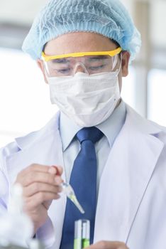 Asian senior scientist have teaching young student scientist in a laboratory.