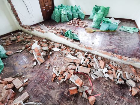 Room and interior and red brick destroyed in the room.