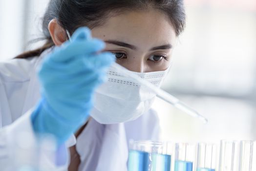 Asian young girl student scientist researching  and learning in a laboratory.