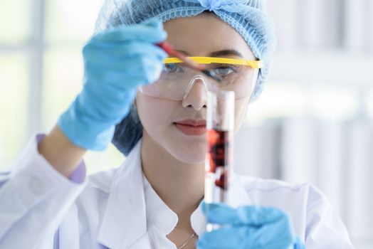 Asian young girl student scientist researching  and learning in a laboratory.