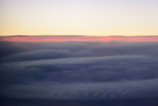 The blue skyline with cloudy in sunrise time, view from window on the plane.