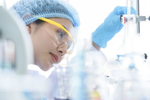 Asian young girl student scientist researching  and learning in a laboratory.