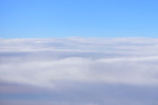 The blue skyline with cloudy in sunrise time, view from window on the plane.