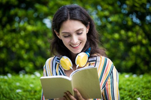 Portrait of a beautiful woman has reading a book with smiling and relax in the garden.