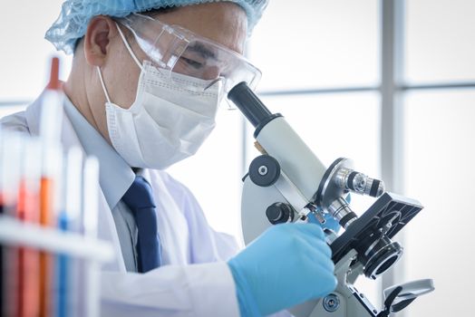 Asian man scientist researching  and learning in a laboratory.