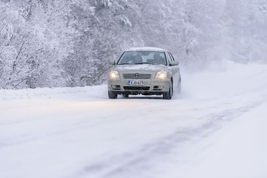 Editorial: Tuupovaara City, Finland, 25th December 2018. Toyota car on the road number 496 with heavy snow in winter season at Tuupovaara, Finland.