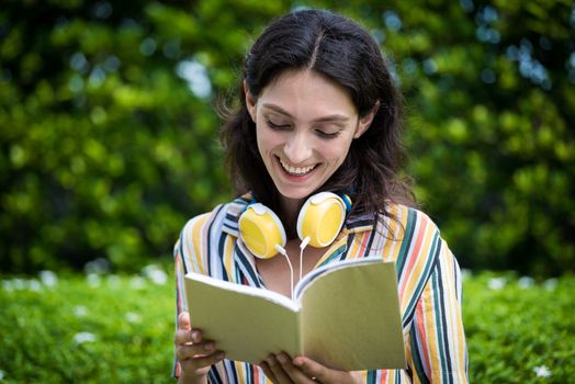 Portrait of a beautiful woman has reading a book with smiling and relax in the garden.