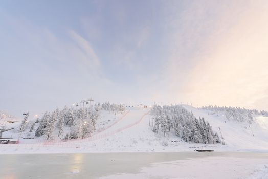 Rukatunturi ski jumping hill in winter season and nice weather and blue sky in winter season and sunset time at Ruka ski Rukatunturi, Finland