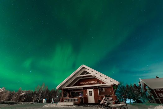 The northern lights Aurora Borealis at Kuukiuru village lake in Lapland, Finland.