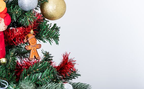 The gingerbread man on Christmas tree isolated on white background.