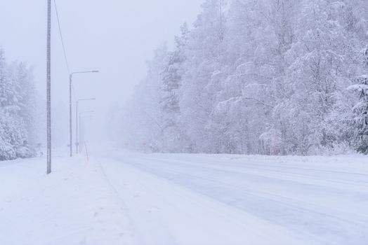 The road number 496  has covered with heavy snow and bad weather in winter season at Tuupovaara, Finland.