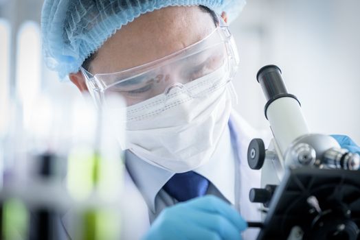 Asian man scientist researching  and learning in a laboratory.