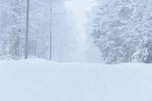 The road number 496  has covered with heavy snow and bad weather in winter season at Tuupovaara, Finland.