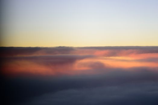 The blue skyline with cloudy in sunrise time, view from window on the plane.