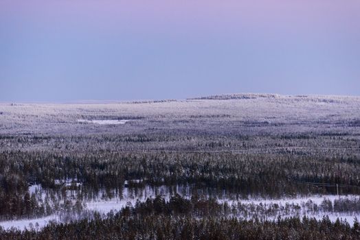 The landscape forest has covered with heavy snow and sunset sky from top view landscape in winter season at Lapland, Finland.